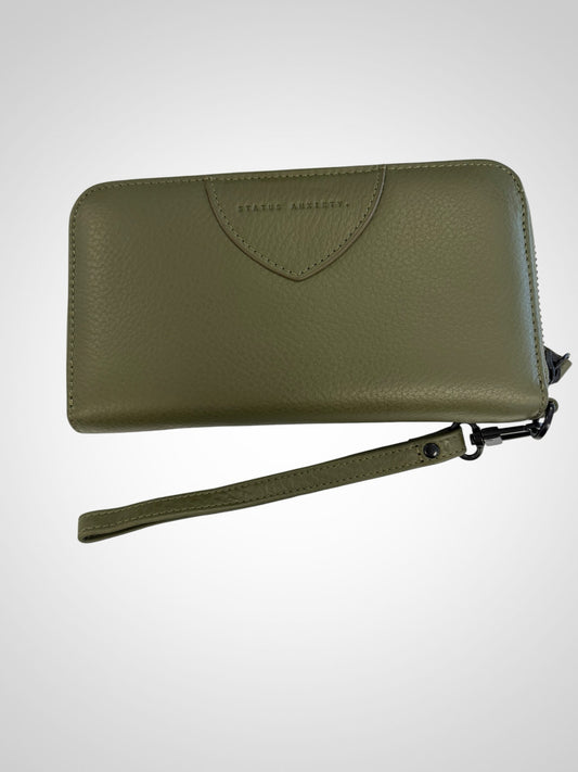Etc. Store Status Anxiety olive green leather wristlet wallet with a detachable strap and zip-around closure.